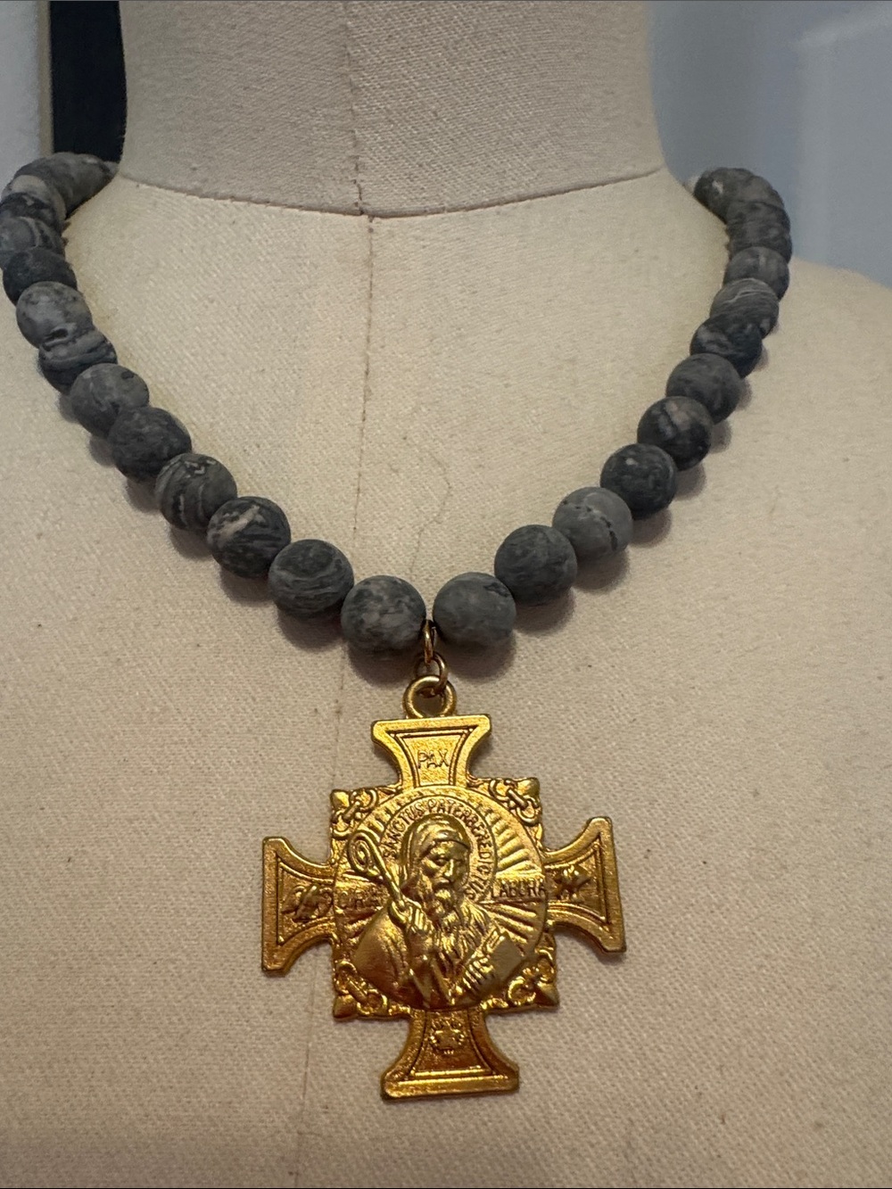 Gold Cross Pendant Necklace on Gray Beaded Strand